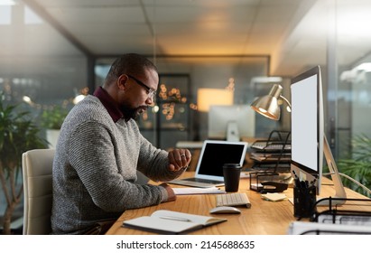 I Didnt Notice The Time. Cropped Shot Of A Handsome Mature Businessman Sitting At His Office Desk And Checking His Watch During A Late Shift.