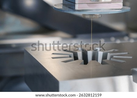 The die insert gear shape cutting process by wire EDM machine control by CNC program. Closeup scene the wire EDM machine cutting the mold insert parts. 