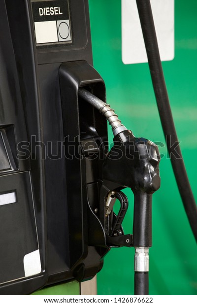 Diesel black nozzle on the pump at the gas station,\
close up
