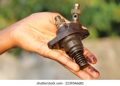 Diesel Fuel Injector From An Old Diesel Engine Held In Hand With A View Of Its Parts