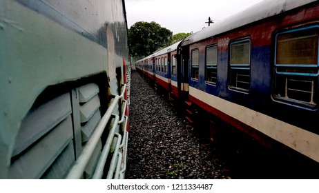Diesel Multiple Unit (DMU) train and an express train crossing (xing).