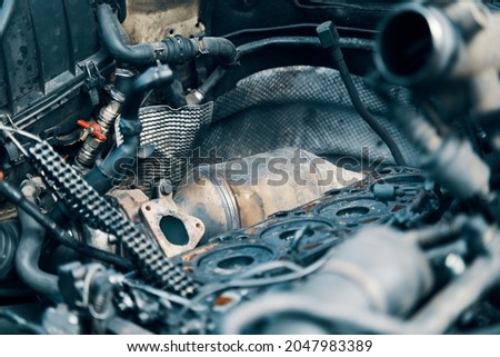 Diesel particulate filter. DPF under the hood near with a semi-disassembled engine. High quality photo