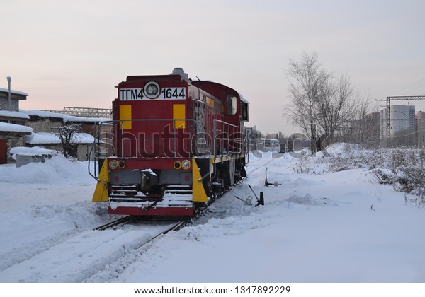 Diesel powered locomotive in the snow. Winter day
on the railway in Russia