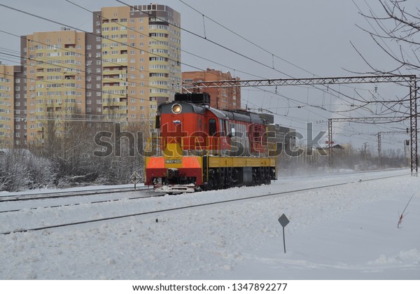 Diesel powered locomotive in the snow. Winter day
on the railway in Russia