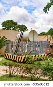 A Diesel Tank For A Generator In Zambia With A Fence And Safety Features With Yellow And Black Warning Signs