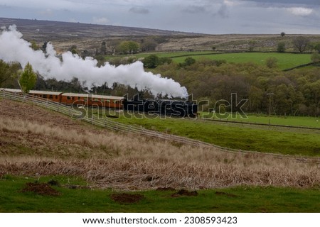  Diesel Train Running on Track NYMR. The North Yorkshire Moors Railway (NYMR) is a heritage railway in North Yorkshire, England, that runs through the North York Moors National Park.