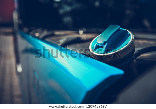 Diesel Truck. Blue\
Fueling Cap Closeup. Heavy Loads Vehicles Economy Theme. Automotive\
and Oil Industry.