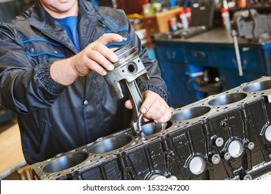 diesel truck engine repair service. Automobile mechanic installing piston into engine