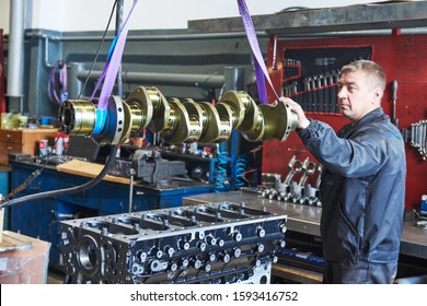 Diesel Truck Engine Repair Service. Automobile Mechanic Installing Crankshaft Into Engine