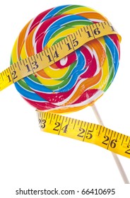 Diet Challenge Concept With Candy Lollipop And Measuring Tape.  Isolated On White With A Clipping Path.