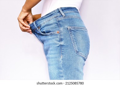 Diet Concept, Woman Wearing Loose Blue Jean Photo Isolate On White Background Sideview Copy Space