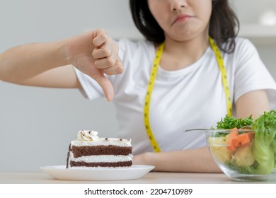 Diet, Dieting Asian Young Woman, Girl Hand Showing Thumb Up Deny, Reject Chocolate Cake, Dessert Food, Choose Eat Green Salad Vegetables When Hungry. Nutritionist Of Healthy, Nutrition Of Weight Loss.