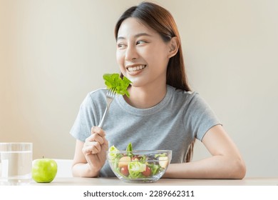 Diet, Dieting asian young woman or girl use fork at lettuce on mix vegetables, green salad bowl, eat  food is low fat good health. Nutritionist female, Weight loss for healthy person. - Powered by Shutterstock