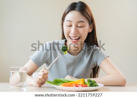 Diet, Dieting asian young woman or girl use fork at broccoli on mix vegetables, green salad bowl, eat  food is low fat good health. Nutritionist female, Weight loss for healthy person.