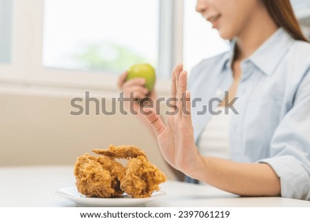 Diet, Dieting asian young woman hand push out, reject fried chicken on plate, deny to eat fast, junk food choose green apple or fruit, girl eat low fat for good healthy, getting weight loss people.