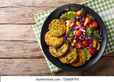 Diet Food: quinoa burgers with spinach and fresh vegetable salad close-up on a plate. Horizontal top view from above
 - Powered by Shutterstock