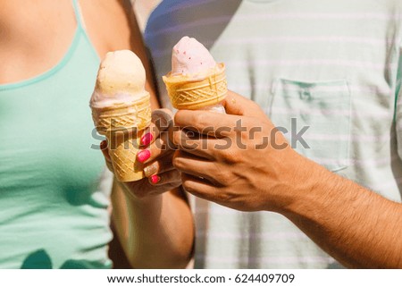 Diet, food, sweets, summer pleasures concept. Man and woman hand holding two ice cream.