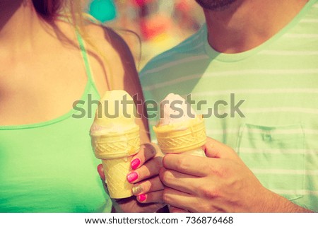 Diet, food, sweets, summer pleasures concept. Man and woman hand holding two ice cream.