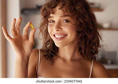 Diet. Nutrition. Healthy Eating, Lifestyle. Close Up Of Happy Smiling Woman Taking Pill With Cod Liver Oil Omega-3 In Morning. Vitamin D, E, A Fish Oil Capsules 