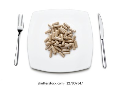 diet pills on plate, on white background