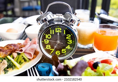 Diet plan with alarm clock as Interval fasting  Healthy diet concept - Shutterstock ID 2102182540