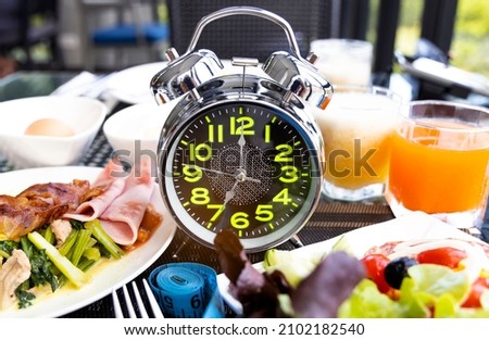 Diet plan with alarm clock as Interval fasting  Healthy diet concept