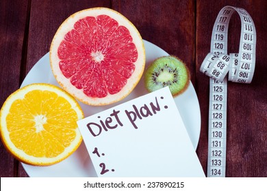 Diet Plan. The Concept Of Weight Loss, Wellness And Healthy Lifestyle. Vegetarian Fruit Diet. Products With Low Fat Content. Plate With Fruits And Measuring Tape.