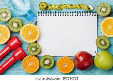 Diet plan, menu or program, tape measure, water, dumbbells and diet food of fresh fruits on blue background, weight loss and detox concept, top view - Powered by Shutterstock