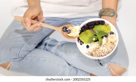 Diet Plan With Woman Hand Eating  Diet Program With Yogurt Blueberry ,avocado,banana,as Granola Parfait In A Bowl With Spoon On White Background-Healthy Food Concept