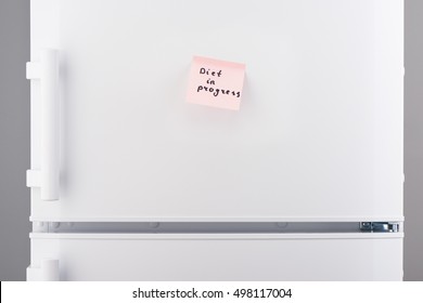 Diet In Progress Note On Light Pink Sticky Paper On White Refrigerator Door