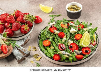 diet summer salad with strawberries, asparagus, arugula, blue cheese and seeds. Food recipe background. Close up. - Powered by Shutterstock