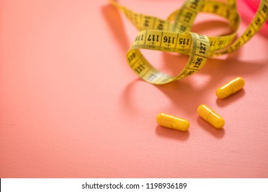 Diet vitamin pills and measure tape