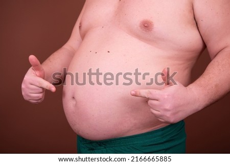Diet and weight problem. A man with a big belly.	