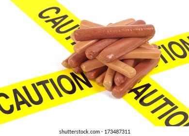 Dietary Fast Food Warning, Caution Of High Cholesterol And Saturated Fat, Unhealthy Nutrition Concept Image (Variety Of Beef Sausages, Wieners And Hot Dogs Wrapped In Yellow Caution Tape)