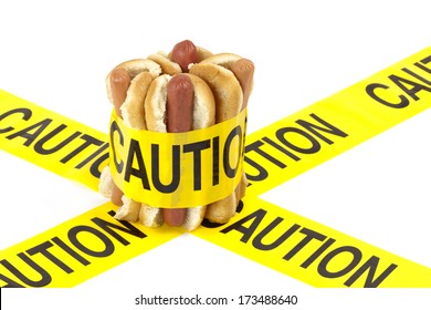 Dietary Fast Food Warning, Caution Of High Cholesterol And Saturated Fat, Unhealthy Nutrition Concept Image (Beef Sausages, Wieners And Hot Dogs With Buns Wrapped In Yellow Caution Tape)