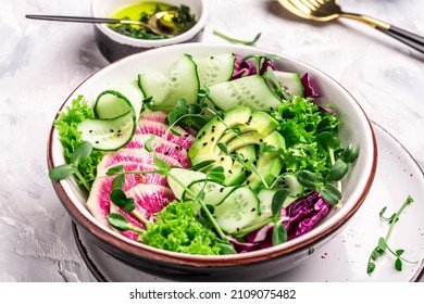 Dietary menu. watermelon radish, avocado lettuce, microgreen cucumber and radish salad, Top view. Flat lay, Restaurant menu, dieting, cookbook recipe.