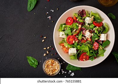 Dietary Salad With Tomatoes, Feta, Lettuce, Spinach And Pine Nuts. Top View. Flat Lay.