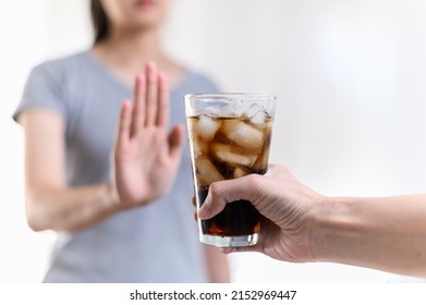Dieting or good health concept. Young woman rejecting Junk food or unhealthy food such as sweet soda drink and choosing healthy food such as fresh fruit or vegetable. - Shutterstock ID 2152969447