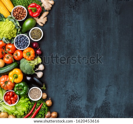 Dieting and healthy eating concept: fruits, vegetables, vegan food ingredients over natural background.