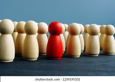 Difference, dissimilarity and distinctness concept. Wooden figures on a desk. - Shutterstock ID 1259195101