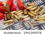 Difference of size of ammunition gun bullets on daimond plate background  