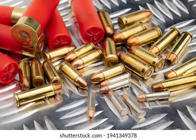 Difference of size of ammunition gun bullets on daimond plate background  