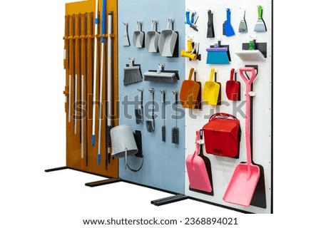 difference type home and garden tool hanging on board such as dustpan mob etc. isolated on white with clipping path
