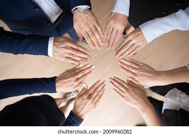 Different Aged Business Team Standing In Circle, Making Circular Shape Of Hands, Open Palms. Corporate Coworkers Engaged In Teamwork Activities For Growing Community Motivation. Close Up, Top View