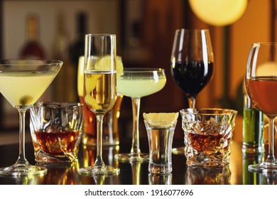 Different alcohol drinks on table in bar