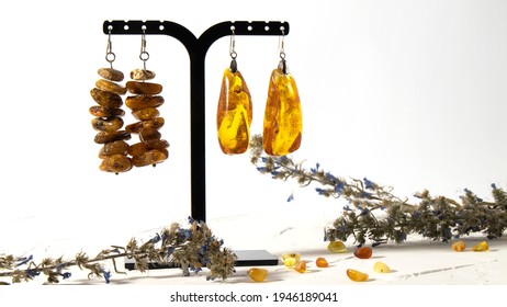 Different amber earrings on a white background. 