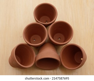 Different angles of terracotta pots waiting to be filled with potting mix and plants.