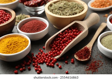 Different aromatic spices on grey table, closeup - Powered by Shutterstock