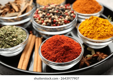 Different aromatic spices on light grey table, closeup
