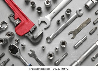 Different auto mechanic's tools on grey table, flat lay - Powered by Shutterstock